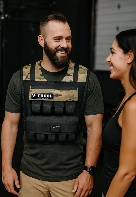 Man wearing a weight vest and talking to woman