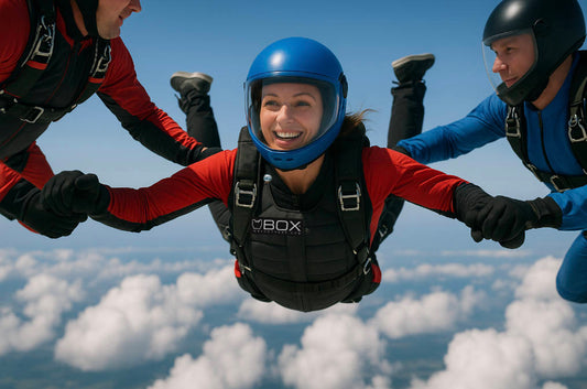 Female skydiver wearing a compact weight vest in formation with teammates, using added weight to match fall speed