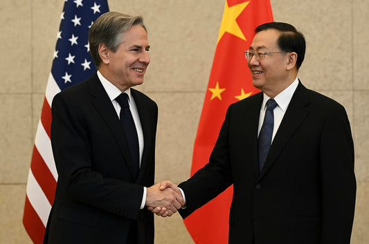 U.S. diplomat shaking hands with Chinese government official during international trade meeting with American and Chinese flags in background